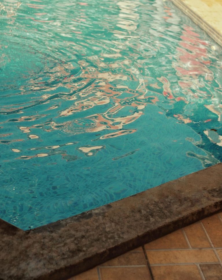 Calm and tranquil swimming pool with shimmering water effects.